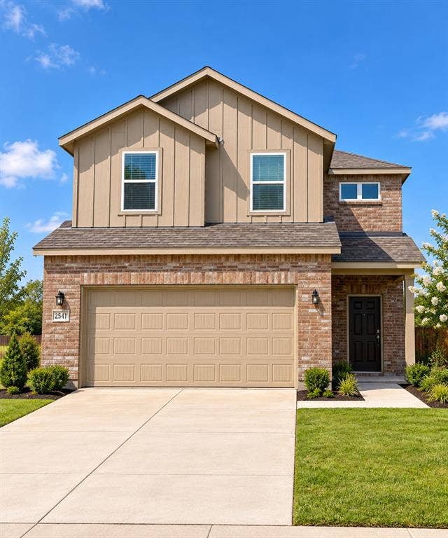 Two-story exterior featuring a brick and vertical siding facade, gabled roofline, concrete driveway, and attached two-car garage