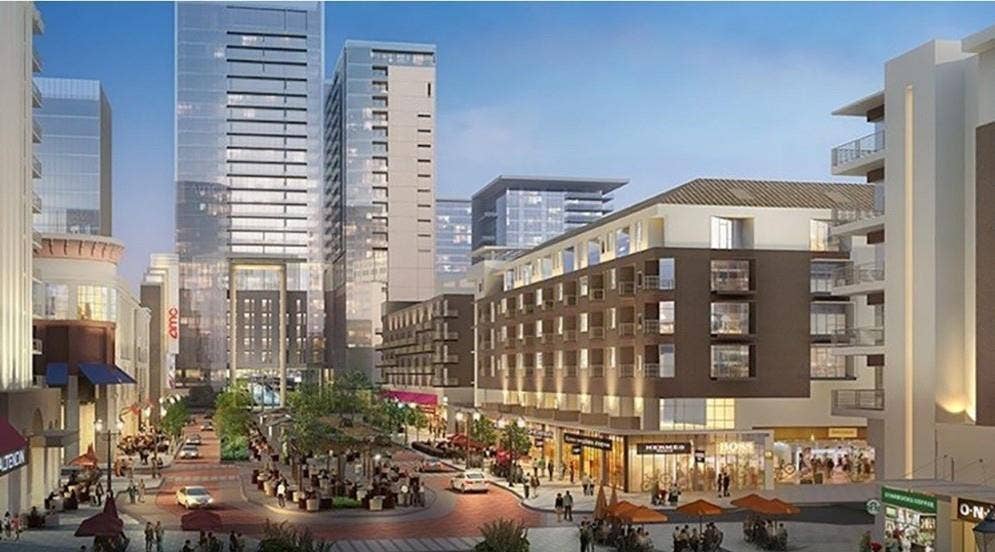 5623 Harvest Hill Road, #2023, Dallas, TX 75230 High-density urban development featuring contemporary multi-story structures, integrated ground-level retail space, private balconies, and paved pedestrian plazas