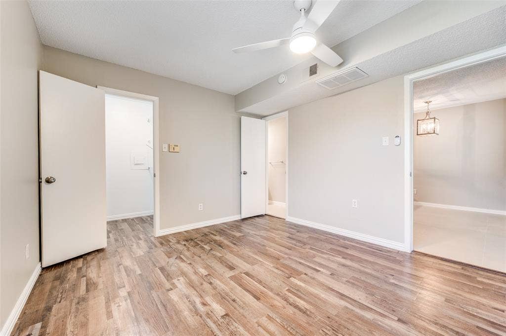 5623 Harvest Hill Road, #2023, Dallas, TX 75230 Interior room featuring Wood-look luxury vinyl planks (LVP) a ceiling fan with integrated lighting, and neutral wall tones