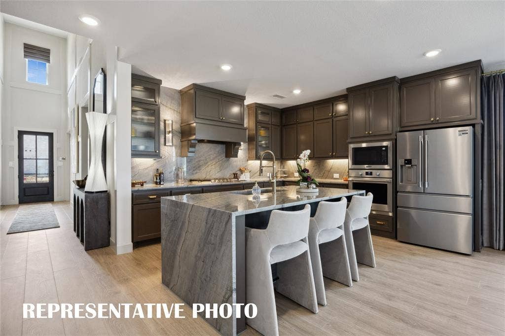 Featuring outstanding storage and prep space, the chef in the family will fall in love with this dream kitchen!  REPRESENTATIVE PHOTO