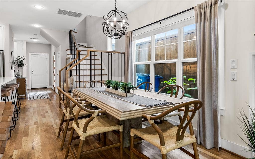 406 Parkview Avenue, Dallas, TX 75223 Dining area featuring a notable chandelier and light hardwood / wood-style floors