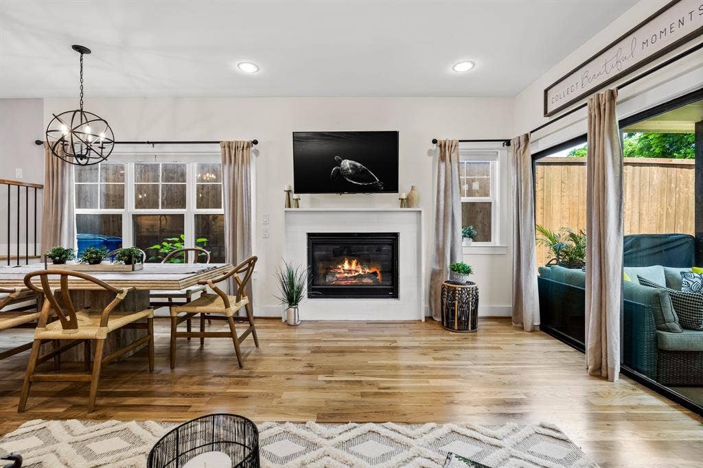406 Parkview Avenue, Dallas, TX 75223 Living room with an inviting chandelier and light hardwood / wood-style flooring