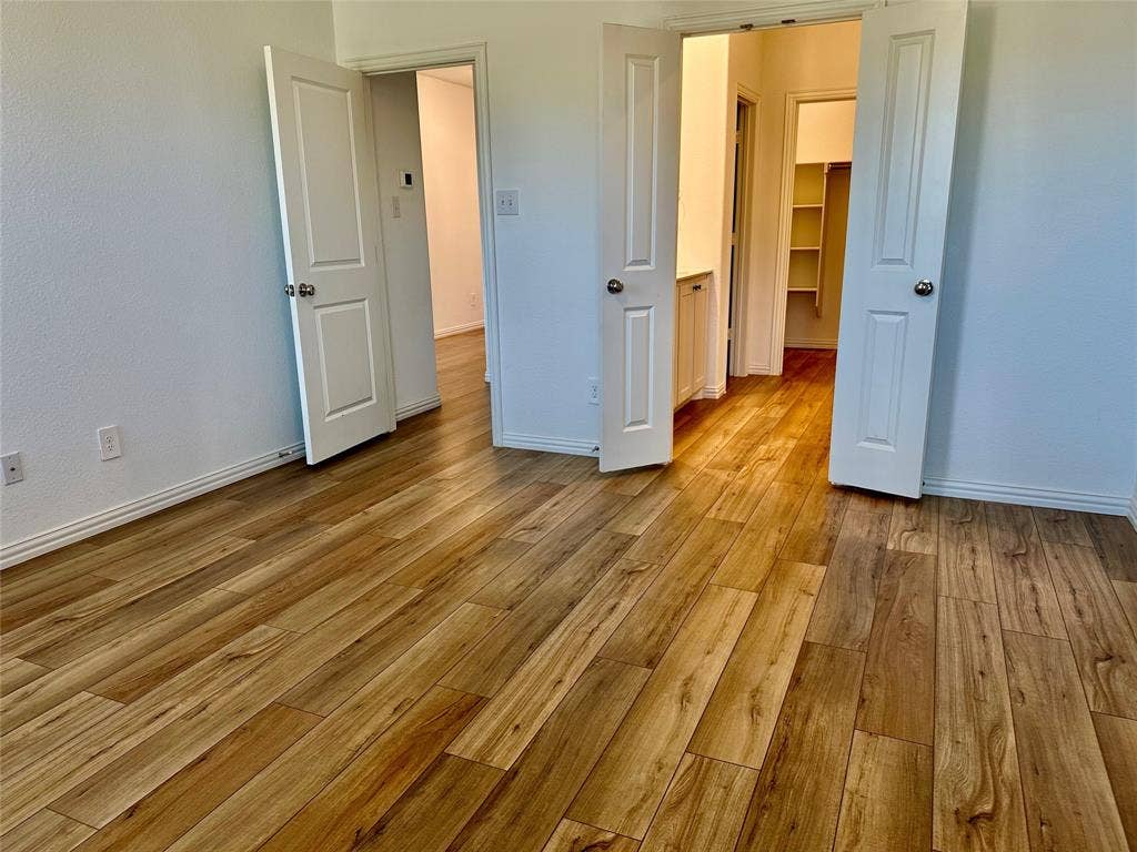 Wood-finish flooring, multi-panel interior doors, and built-in closet shelving