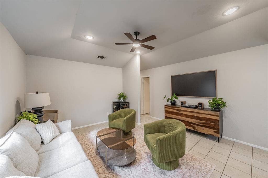1128 Vaulted ceiling featuring recessed lighting and a central ceiling fan, paired with neutral-toned ceramic tile flooring