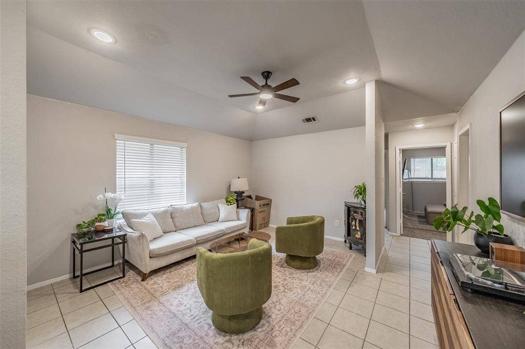 1128 Vaulted ceiling with recessed lighting and a central ceiling fan, neutral wall paint, and large-format tile flooring