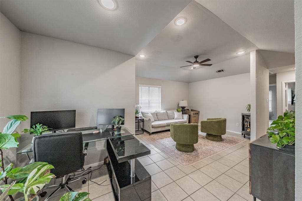 1128 Open-concept interior featuring vaulted ceilings, recessed lighting, tile flooring, and a ceiling fan