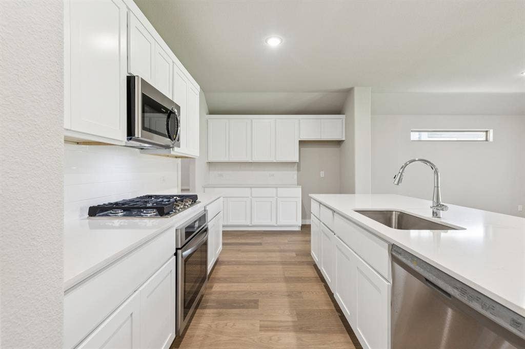 711 Edgehurst Drive, Princeton, TX 75071 Kitchen in the Heisman home plan – REPRESENTATIVE PHOTO