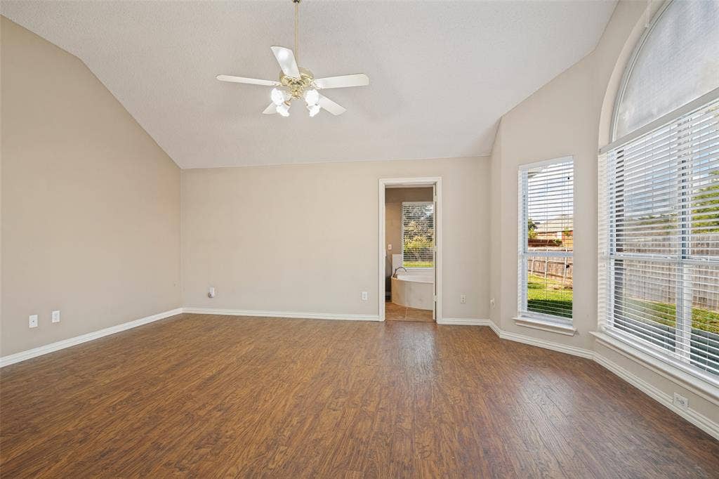 1909 Blackfoot Trail, Mesquite, TX 75149 Vaulted ceilings, wood-finish flooring, arch-top windows, and a multi-light ceiling fan