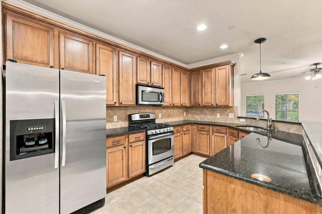Abundant cabinetry, granite countertops, stainless steel appliances, and a generous serving bar to create all of your culinary delights.