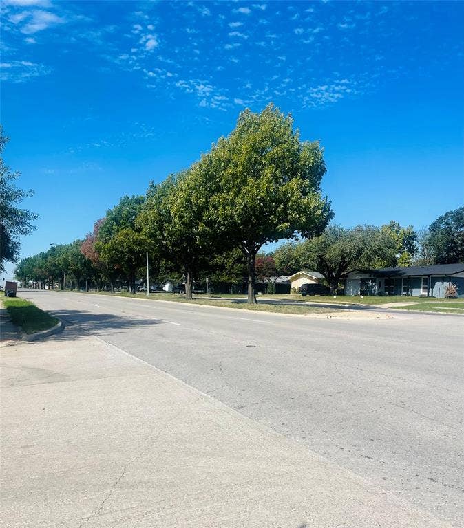 3004 Royal Lane, Dallas, TX 75229 Concrete street featuring concrete sidewalks and mature trees