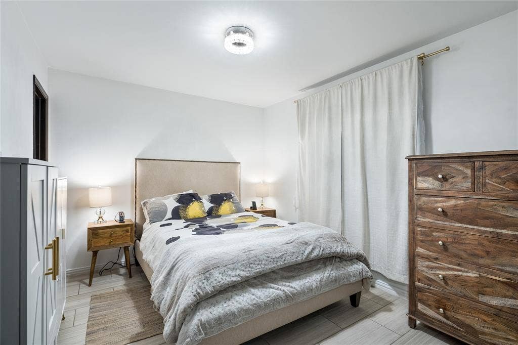 Neutral-toned space featuring light wood-finish flooring and a contemporary circular flush-mount ceiling light