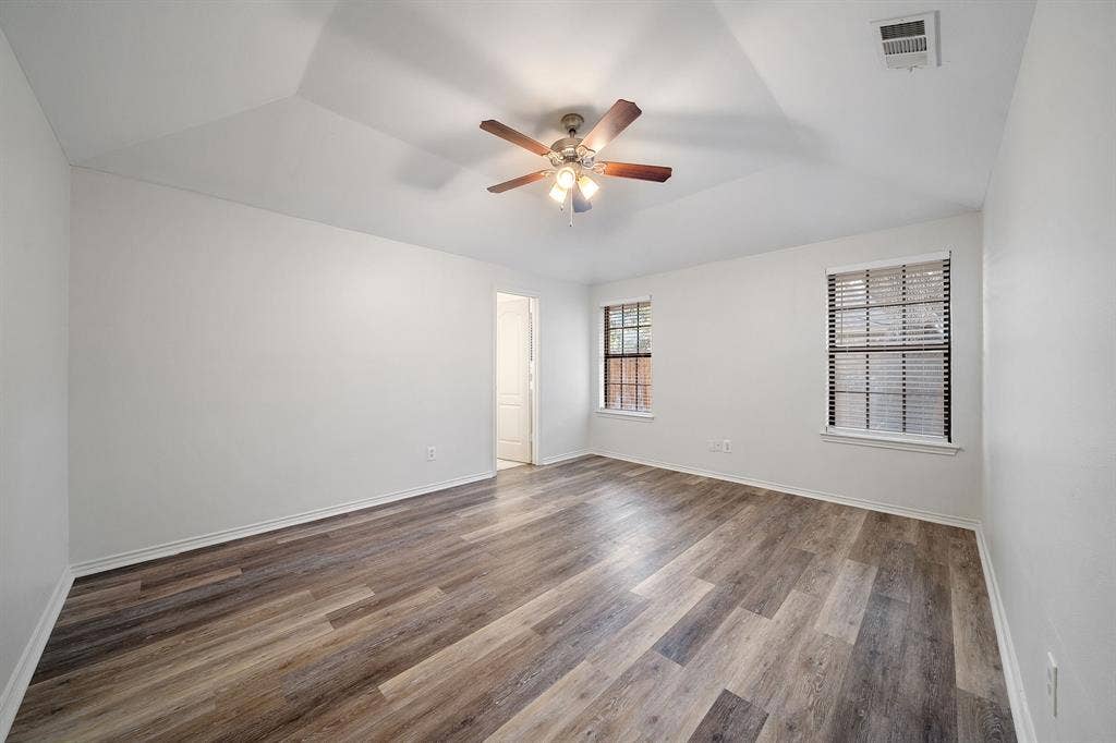 4043 Country Meadows Circle, Granbury, TX 76049 Room featuring tray ceilings, wood-finish flooring, and a ceiling fan with integrated lighting