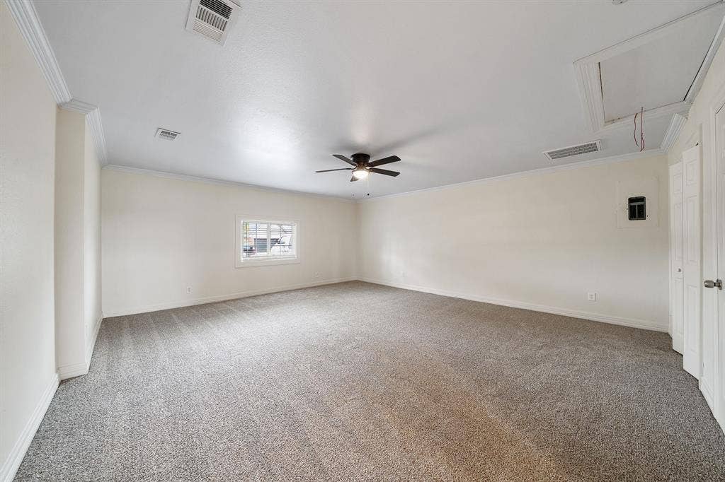 4043 Country Meadows Circle, Granbury, TX 76049 Neutral-toned interior space featuring wall-to-wall carpeting, crown molding, a central ceiling fan, and double-door closet storage