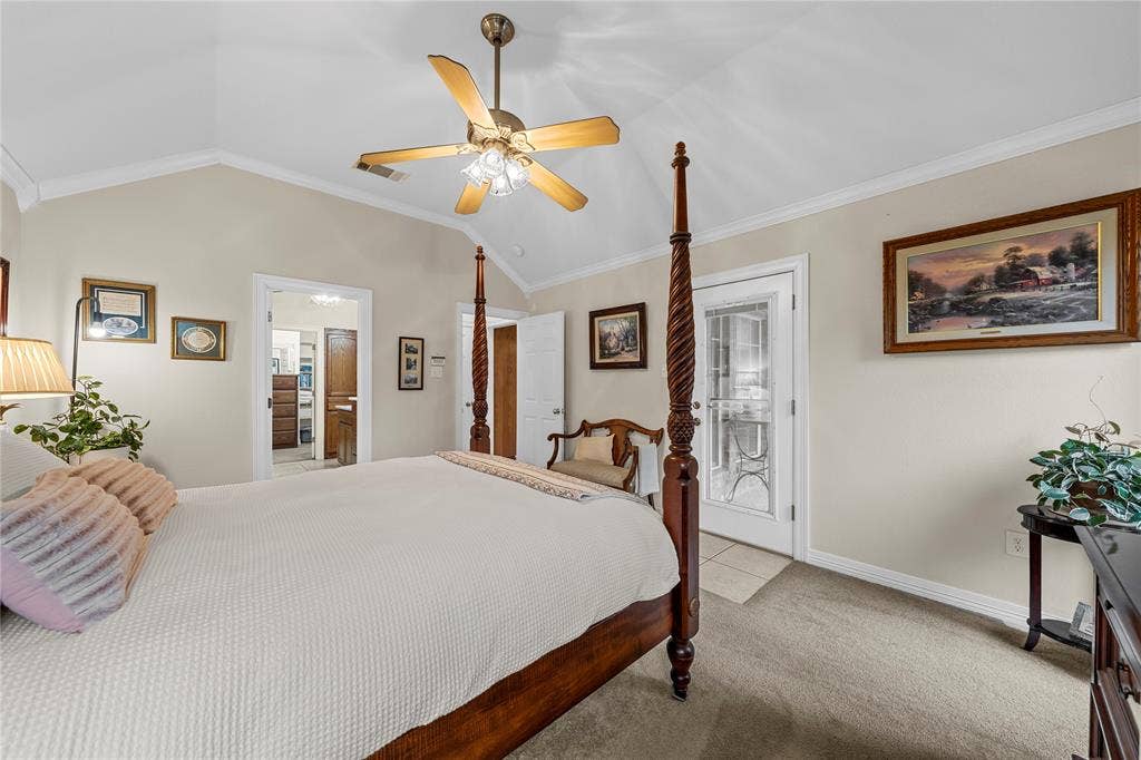 Vaulted ceilings, neutral wall tones, multi-light ceiling fan, and a glass-paneled exterior door