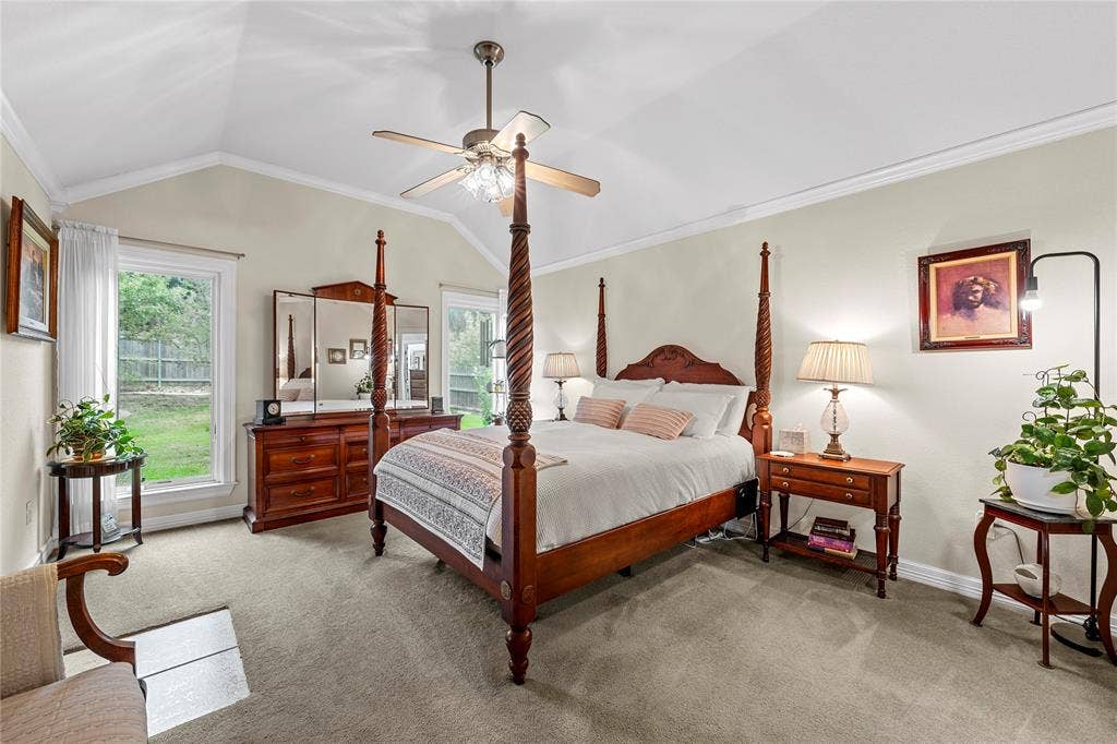 Vaulted ceiling featuring a central brushed-nickel ceiling fan with integrated light fixture and neutral wall-to-wall carpeting