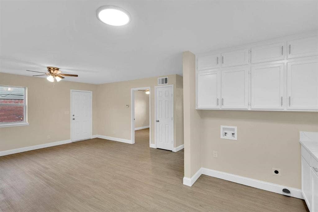 705 George Hopper Road, Midlothian, TX 76065 Utility area featuring white built-in cabinetry, wood-finish flooring, ceiling fan with light kit, and flush-mount ceiling lighting