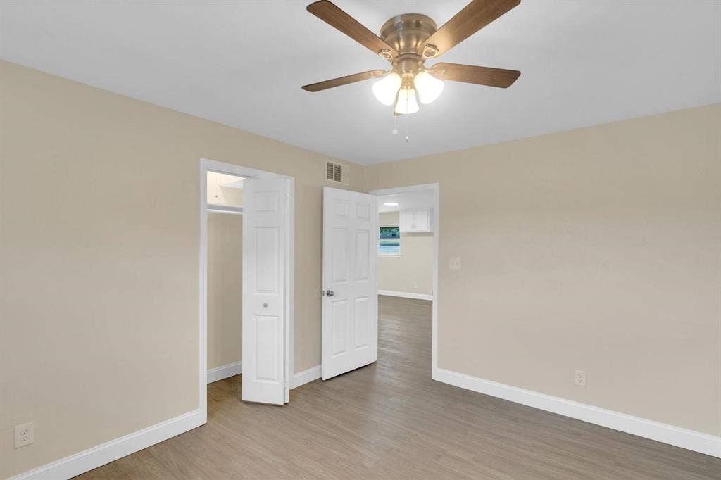 705 George Hopper Road, Midlothian, TX 76065 Interior space featuring wood-finish flooring, a ceiling fan with integrated lighting, and a closet with bifold doors