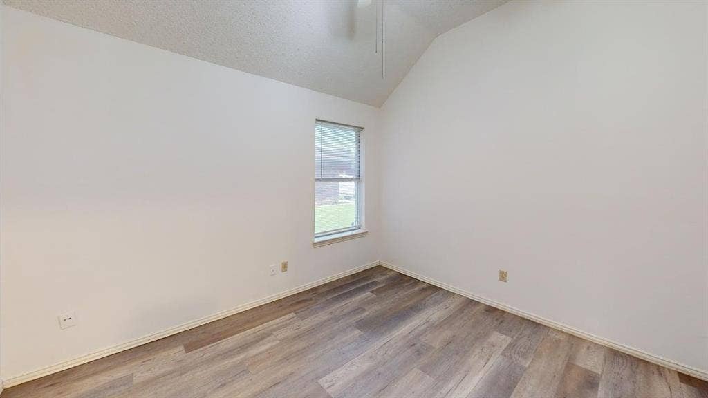 733 Rockett Lane, Cedar Hill, TX 75104 Room with vaulted ceilings, wood-finish flooring, and single-pane window with blinds