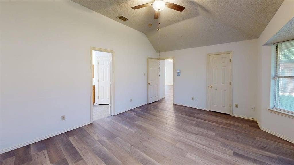 733 Rockett Lane, Cedar Hill, TX 75104 Vaulted ceiling featuring a central lighted ceiling fan, wood-finish flooring, and a recessed window area