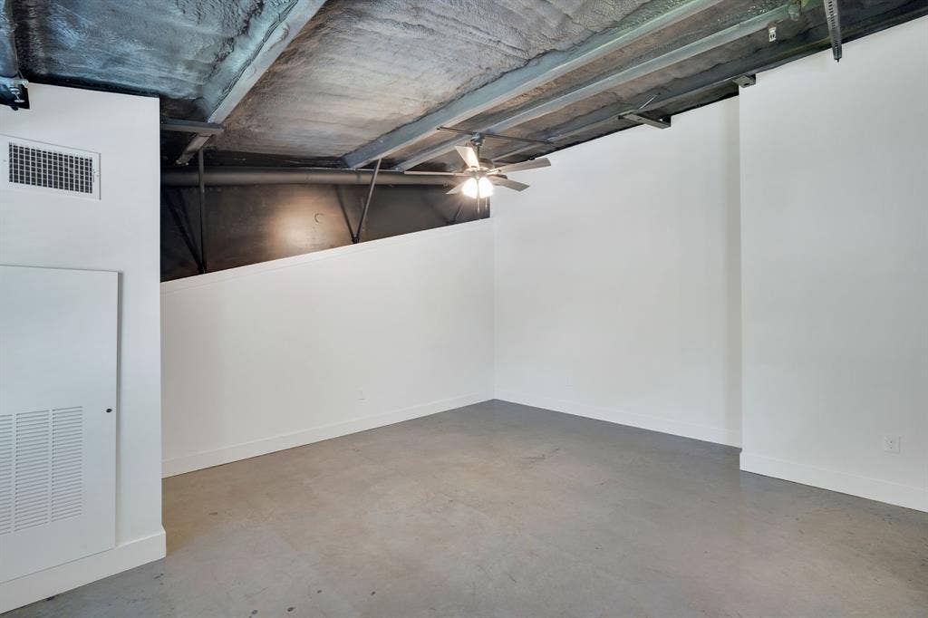 301 W Main Street, #252, Midlothian, TX 76065 Industrial-style room featuring high exposed ceilings, concrete flooring, crisp white walls, and a center-mounted ceiling fan
