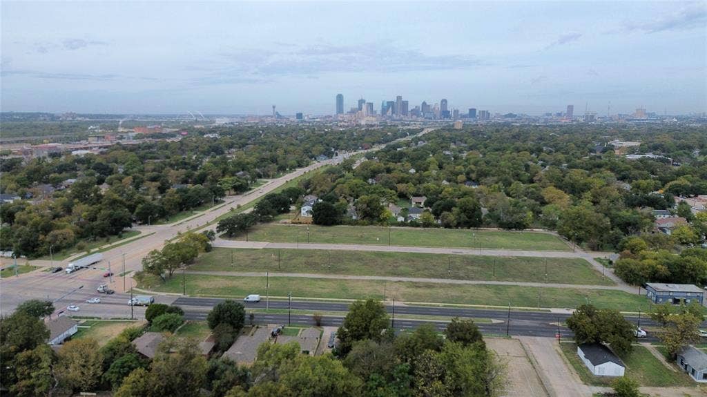 Expansive parcel of land featuring corner placement, proximity to major thoroughfares, and a skyline horizon