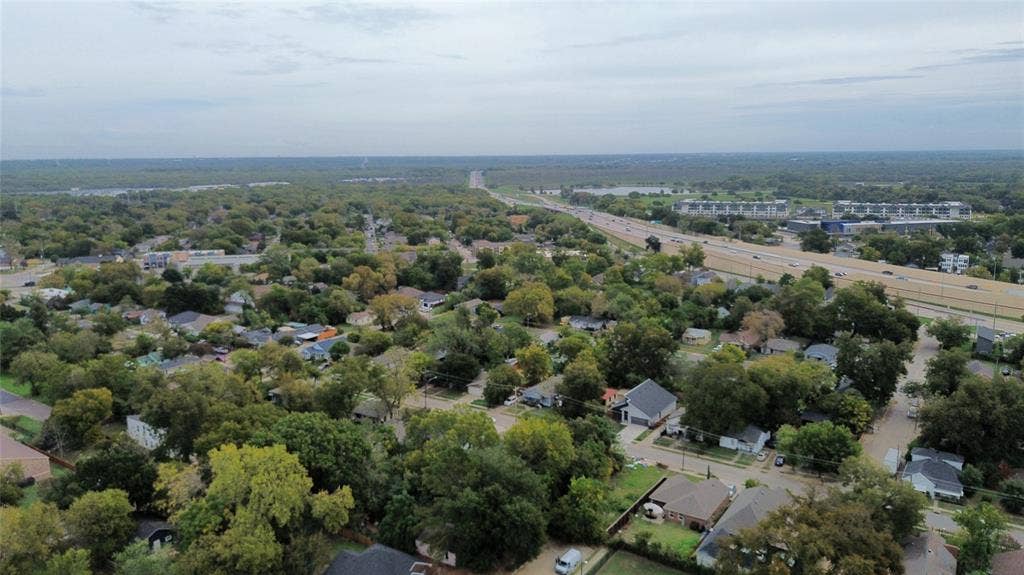 Aerial perspective of the residential area featuring mature tree canopy, established neighborhood grid, and proximity to regional infrastructure