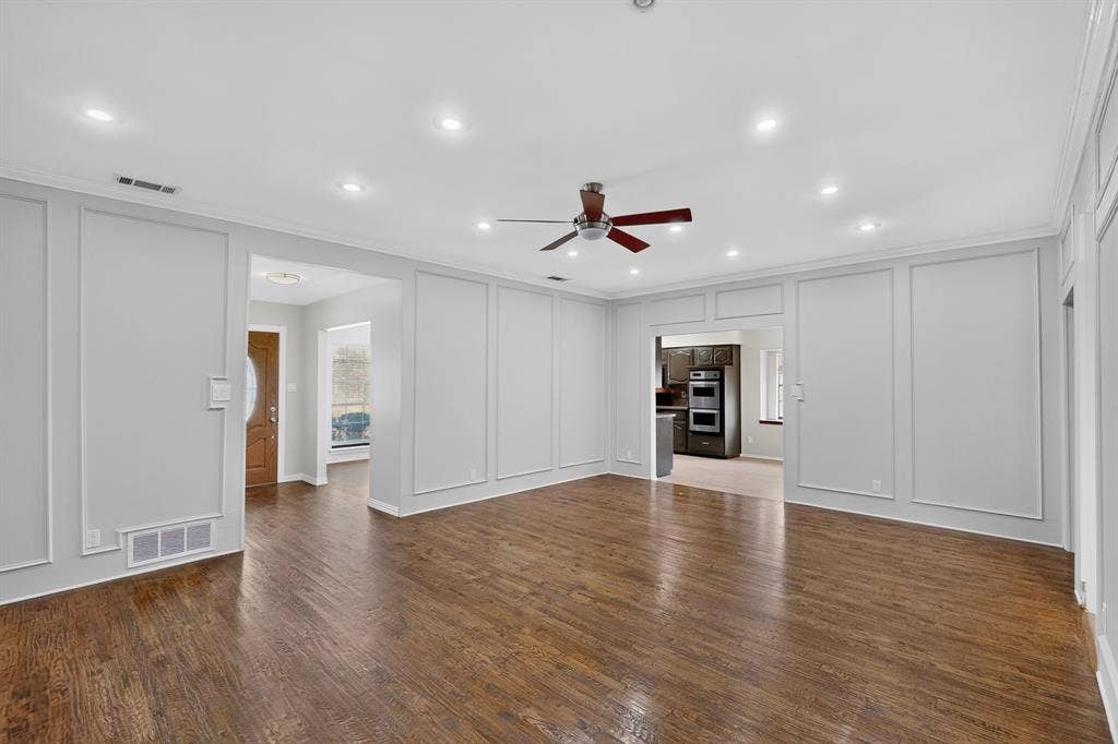 2413 Club Meadow Drive, Garland, TX 75041 Hardwood flooring throughout, recessed lighting, and decorative wall paneling