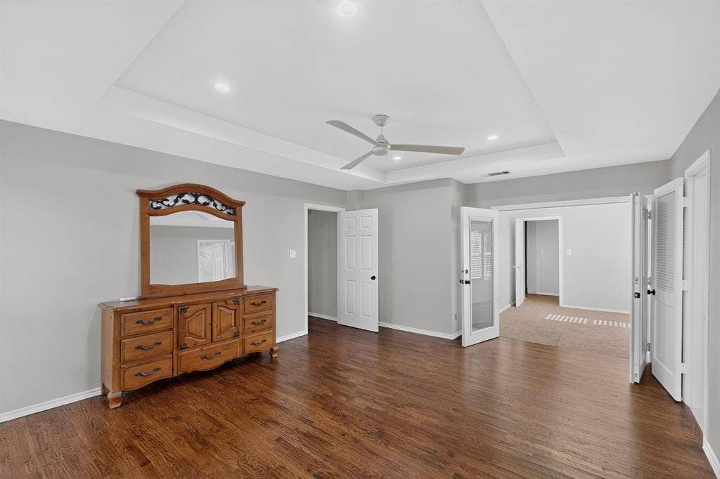2413 Club Meadow Drive, Garland, TX 75041 Wood-finish flooring, tray ceiling, recessed lighting, ceiling fan, and French doors