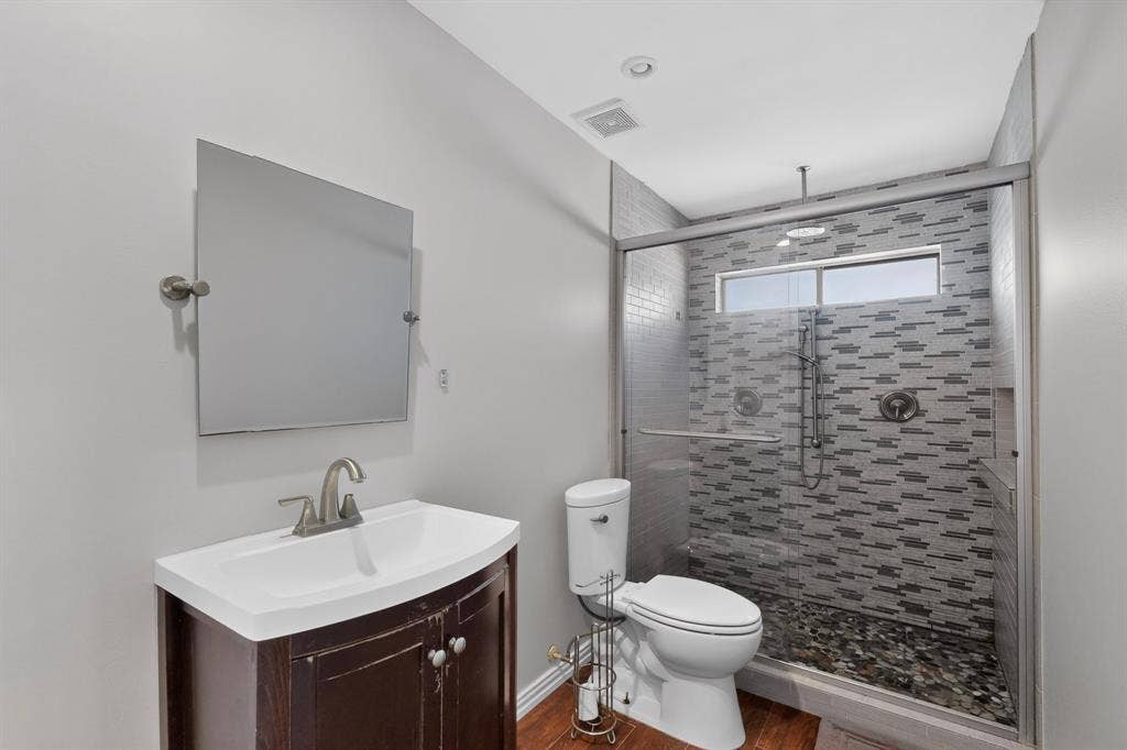 2413 Club Meadow Drive, Garland, TX 75041 Glass-enclosed shower with mosaic tile surround and river rock base