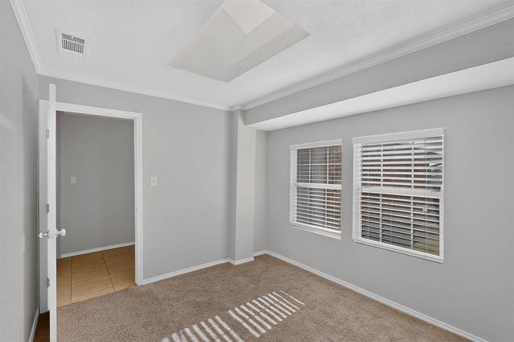 2413 Club Meadow Drive, Garland, TX 75041 adjoining study Recessed ceiling light, crown molding, two windows with blinds, light-colored carpeting, and a doorway to a tiled space