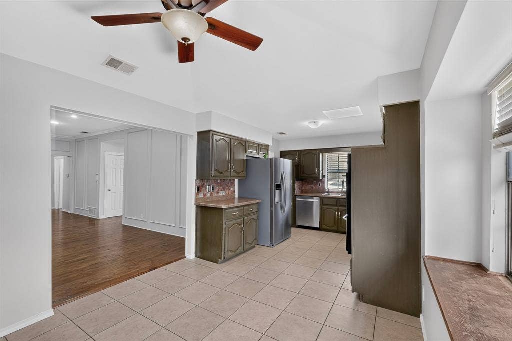 2413 Club Meadow Drive, Garland, TX 75041 Kitchen featuring tile flooring, painted cabinetry, and stainless steel appliances