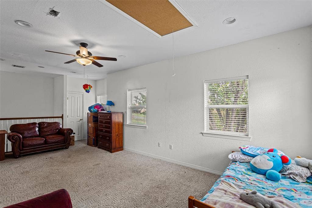 Spacious interior featuring carpeting, recessed lighting, a ceiling fan, and two windows