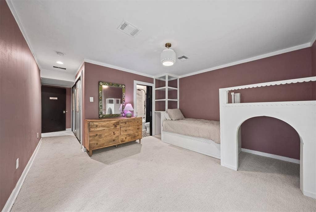 605 Ranier Circle, Garland, TX 75041 Room featuring neutral carpeting, recessed ceiling lighting, a pendant light fixture, and custom built-in white millwork with integrated shelving and an arched structural element
