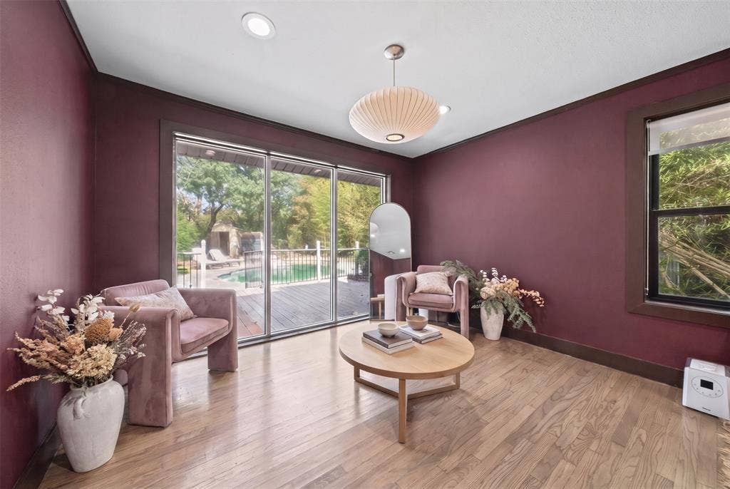 605 Ranier Circle, Garland, TX 75041 Wood-finish flooring, sliding glass door, recessed lighting, pendant light fixture, and dark-toned wall trim