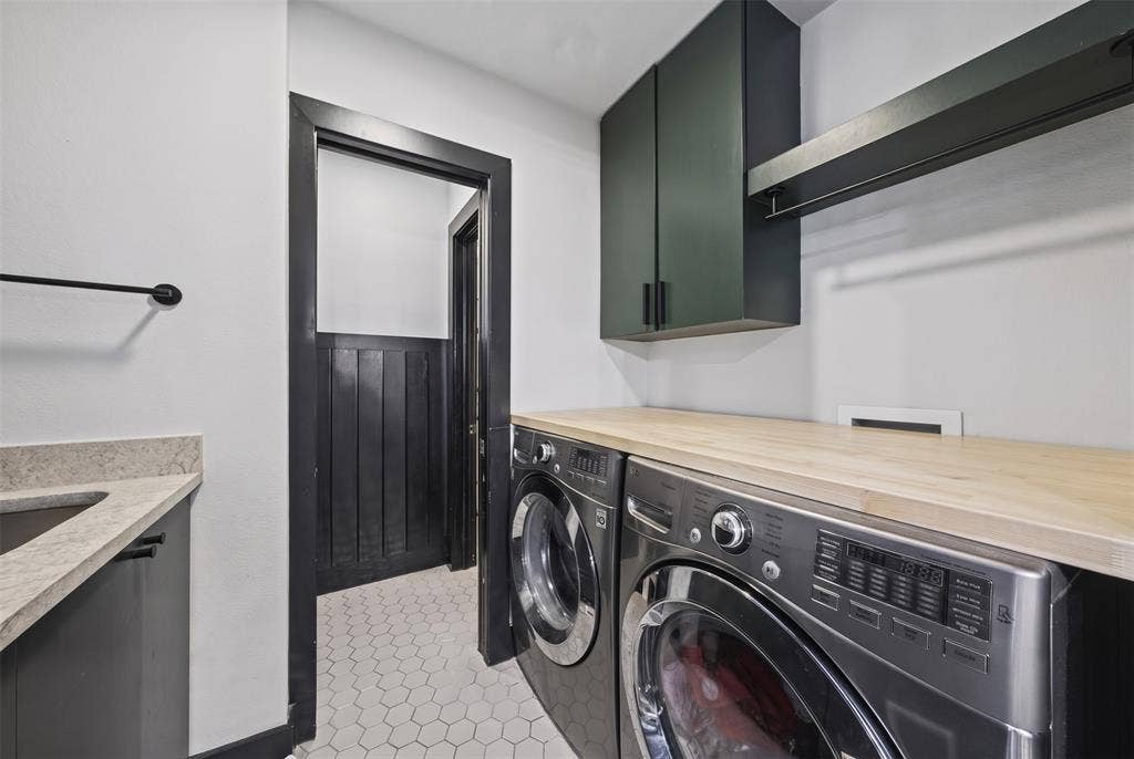 605 Ranier Circle, Garland, TX 75041 Utility room featuring wood-finish countertop, deep-toned wall-mounted cabinetry, integrated hanging rail, stone-finish sink deck, and hexagon floor tiling