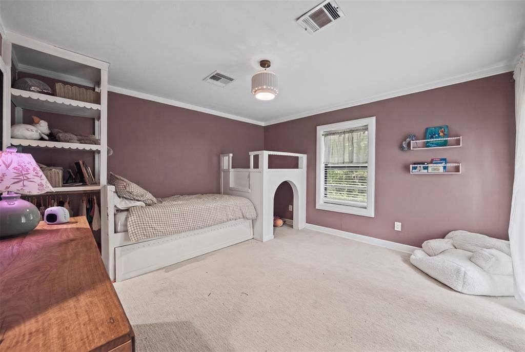 605 Ranier Circle, Garland, TX 75041 Built-in white shelving unit, custom white millwork structure, wall-mounted floating shelves, neutral wall-to-wall carpeting, and center-mount flush light fixture