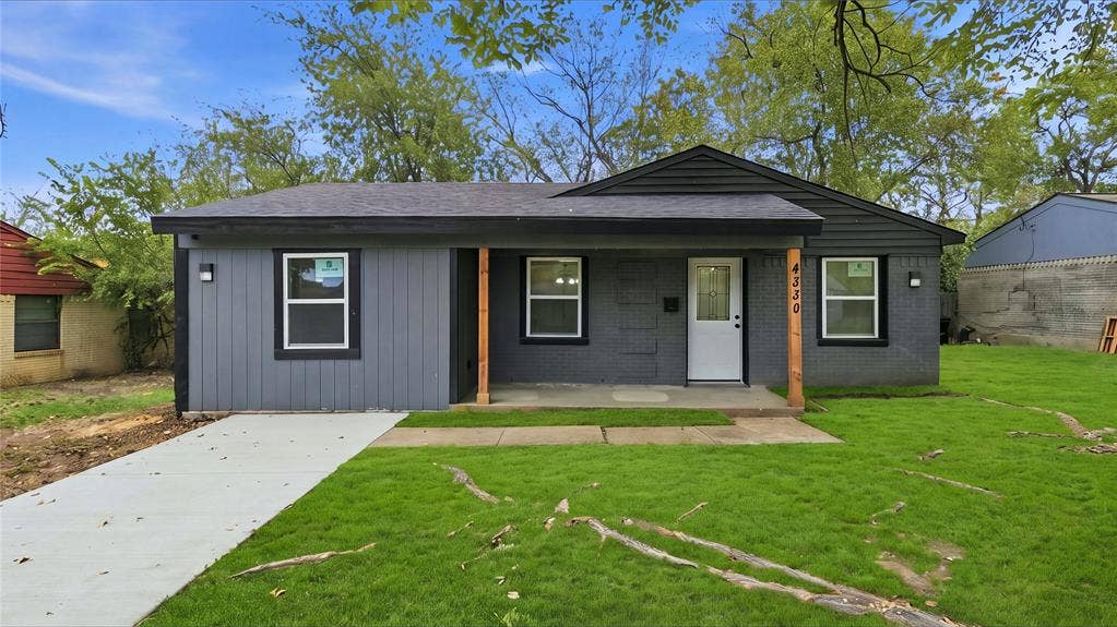 4330 Scottsdale Drive, Mesquite, TX 75150 Single-story exterior featuring painted brick and vertical siding, a covered front porch with natural wood support posts, and a concrete driveway