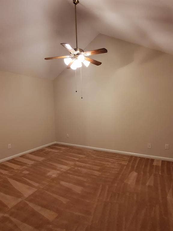Vaulted ceilings featuring a central five-blade ceiling fan with integrated multi-bulb lighting and wall-to-wall carpeting