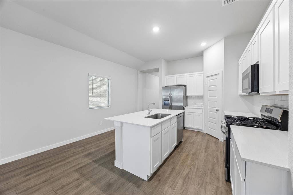 1111 Bridgewalk Drive, Princeton, TX 75071 Kitchen in the Cedar home plan – REPRESENTATIVE PHOTO