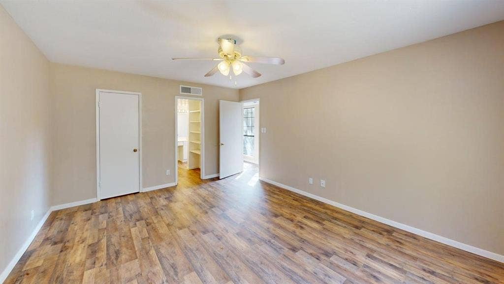 510 Matterhorn Street, Cedar Hill, TX 75104 Neutral interior featuring wood-finish flooring, a multi-blade ceiling fan with integrated light fixture, and an built-in closet with shelving