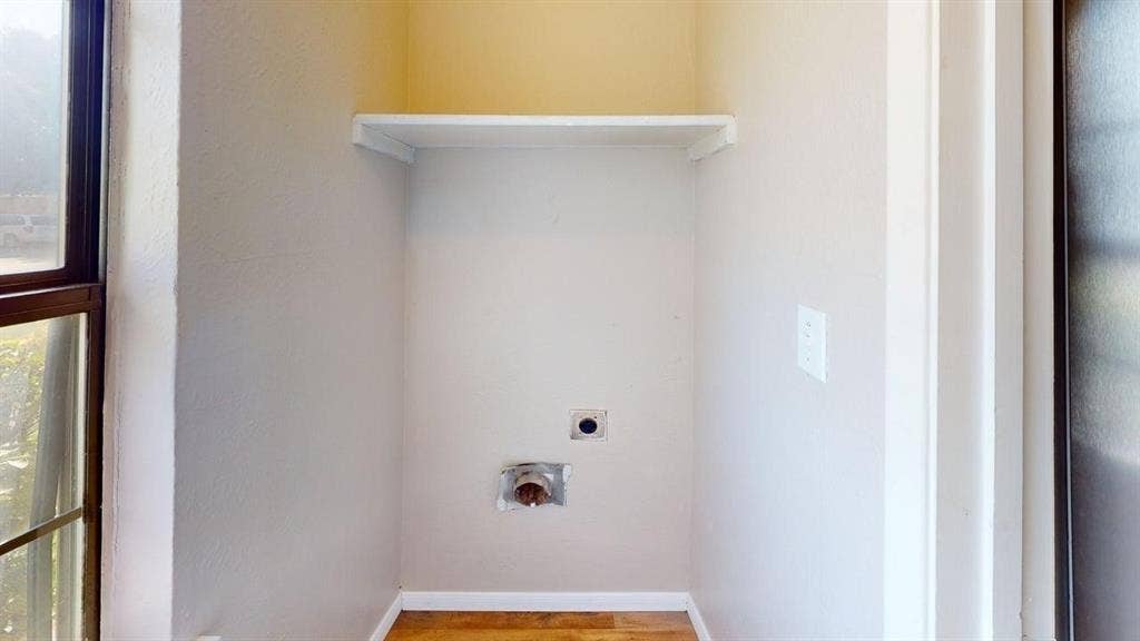 510 Matterhorn Street, Cedar Hill, TX 75104 Dedicated utility alcove featuring wood-finish flooring, neutral wall paint, and built-in overhead shelving