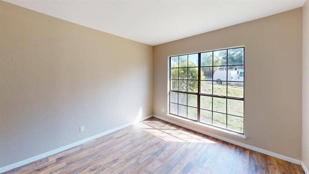 510 Matterhorn Street, Cedar Hill, TX 75104 Neutral wall tones paired with wood-finish flooring and a multi-pane window with dark framing