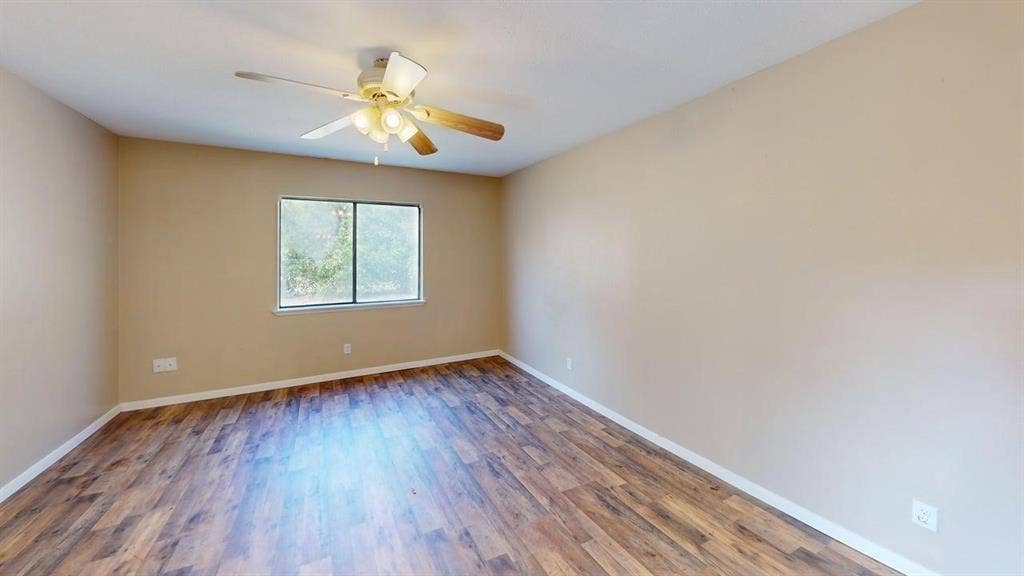 510 Matterhorn Street, Cedar Hill, TX 75104 Room featuring wood-finish flooring, a multi-blade ceiling fan with integrated lighting, and a window with a natural exterior backdrop
