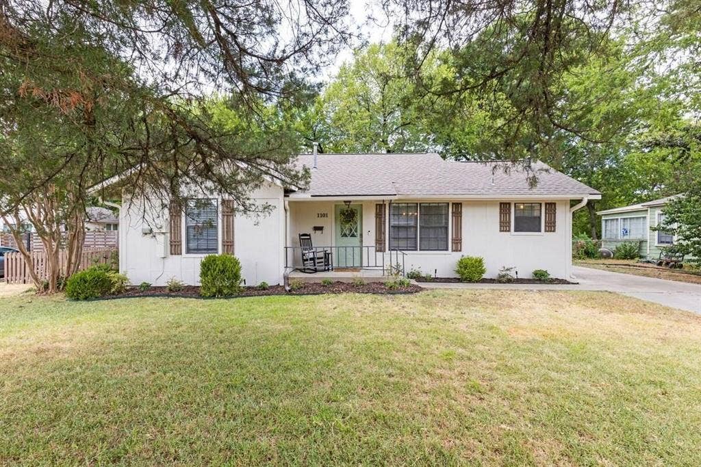 1101 N Waddill Street, McKinney, TX 75069 Single-story exterior featuring light-colored siding, decorative window shutters, a covered front entry, and a concrete driveway