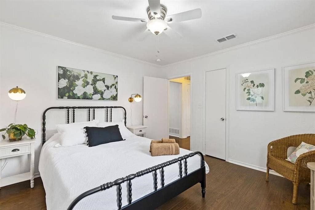 1101 N Waddill Street, McKinney, TX 75069 Wood-finish flooring, ceiling fan with integrated lighting, wall-mounted adjustable light fixtures, and solid-core interior doors