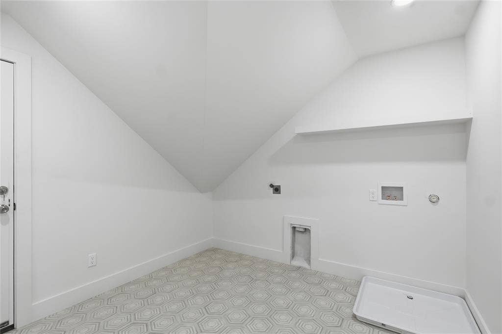 Laundry area featuring geometric patterned floor tiles, white baseboards, a utility sink rough-in, and a built-in shelf