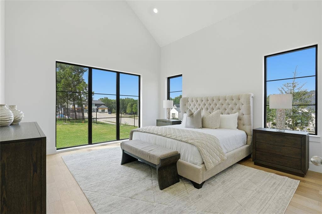 Room featuring a vaulted ceiling, light wood-finish flooring, and bright white walls