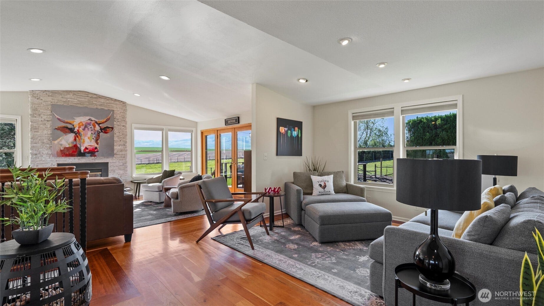 The open great room offers cozy hang-out spaces to gather and take in the views and bucolic vibes.