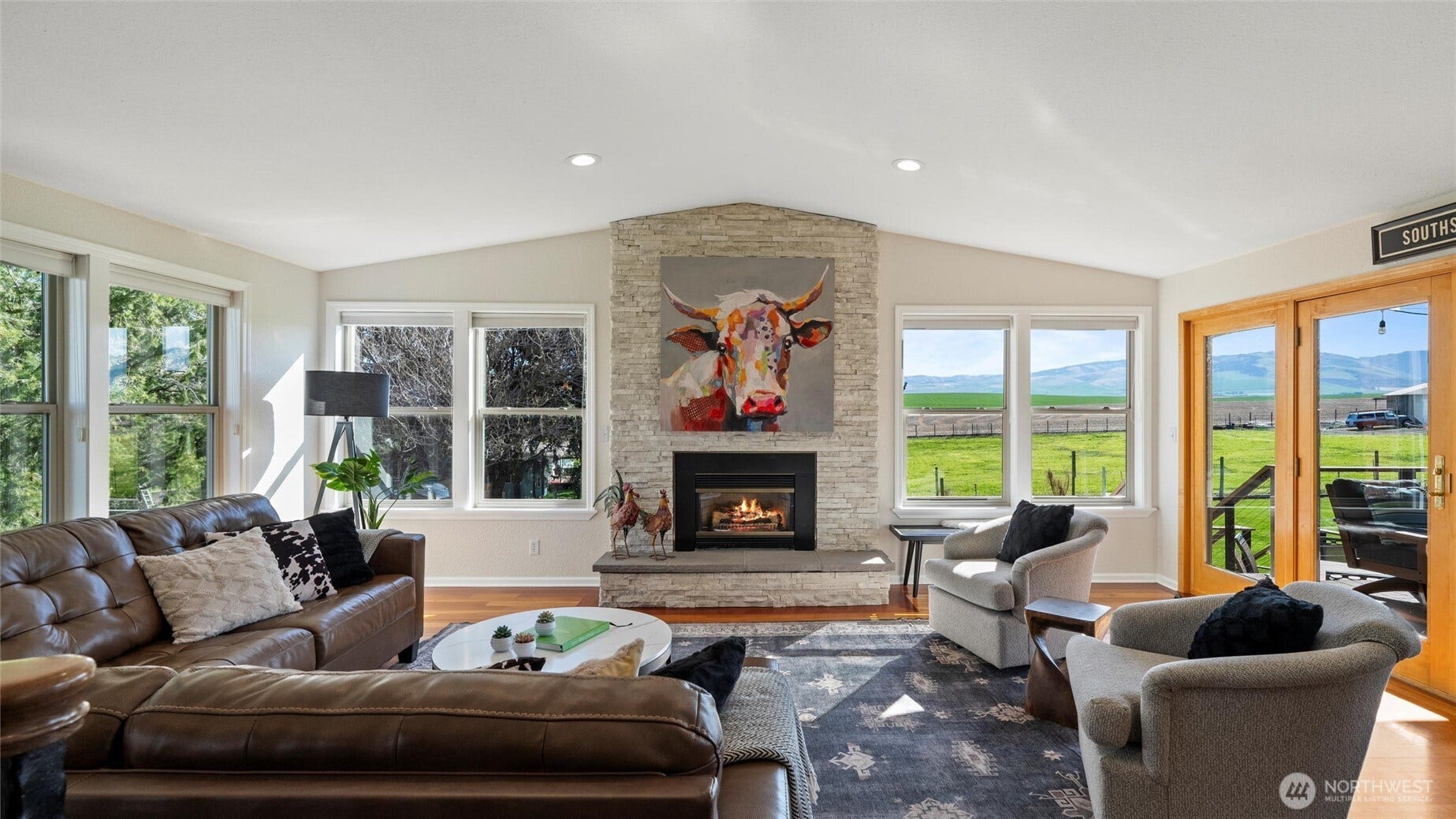 The beautiful vaulted ceilings sit atop the custom stone fireplace and hearth.