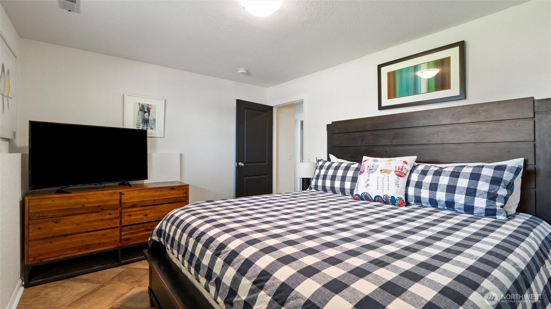 The lower floor has another large bedroom (shown with king bed) and featuring double closets. A nicely remodeled 3/4 bath is directly across the hall.